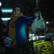 Tim Drake holds up a bag in front of police in Titans.